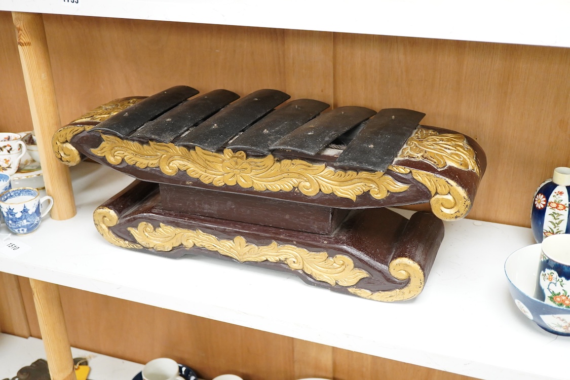 A carved and gilt Balinese Gamelan, 60cm